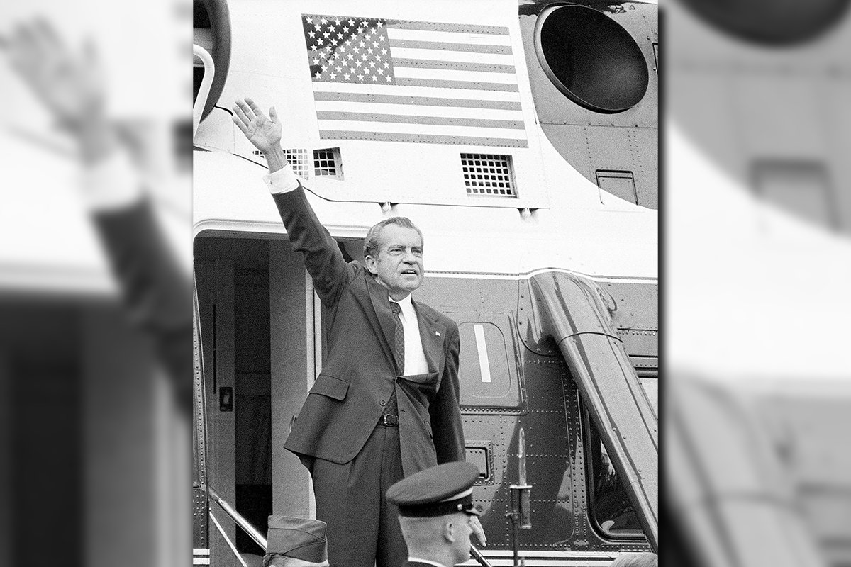In this Aug. 9, 1974 fi le photo, President Richard Nixon waves goodbye from the steps of his helicopter outside the White House, after he gave a farewell address to members of the White House staff. Nixon, who’d been entangled in the Watergate scandal for two years, announced his resignation the next day.